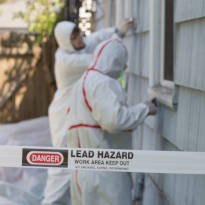 Workers wearing PPE while removing asbestos containing materials (ACM)