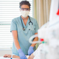 Healthcare worker wearing latex gloves and mask