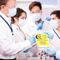 Healthcare workers wearing PPE and checking medical chemicals