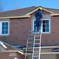 Worker on extension ladder