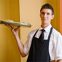 Young worker bringing plate of food to customer