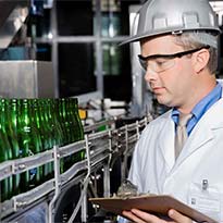 Worker analyzing equipment in operation