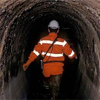Worker walking through tunnel