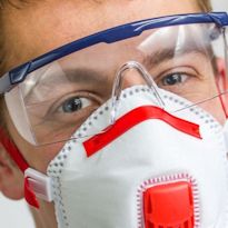 Worker with eye protection and respirator mask