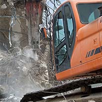 Heavy equipment performing demolition